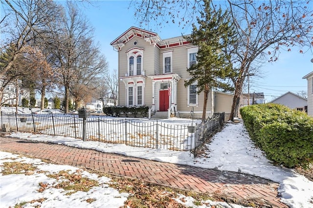 italianate-style house with a fenced front yard