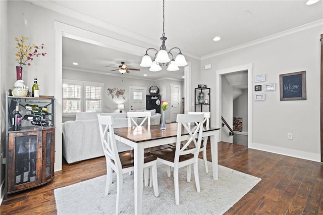 dining room with crown molding, baseboards, wood finished floors, and recessed lighting