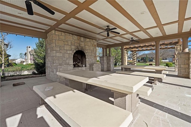9011 NE 79th St, Kansas City, MO 64158 - view of patio / terrace featuring ceiling fan and an outdoor stone fireplace