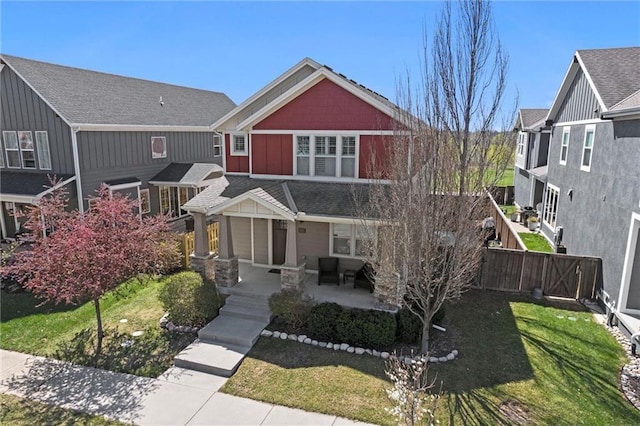 9011 NE 79th St, Kansas City, MO 64158 - view of front of property with a patio, board and batten siding, fence, and a front lawn