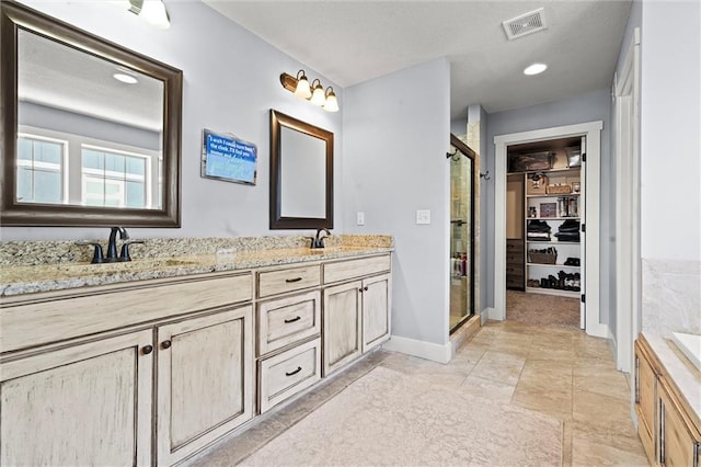 9011 NE 79th St, Kansas City, MO 64158 - bathroom featuring a stall shower, double vanity, a sink, and visible vents