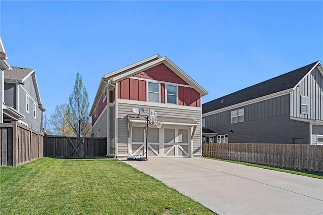 9011 NE 79th St, Kansas City, MO 64158 - view of front of home featuring board and batten siding, an attached garage, driveway, and a front yard