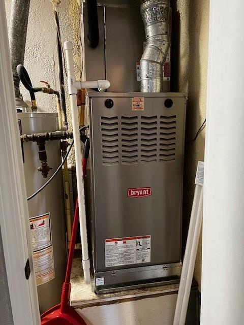 utility room featuring gas water heater