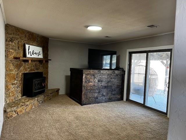 unfurnished living room featuring crown molding, carpet, and a textured ceiling