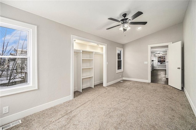 unfurnished bedroom with ceiling fan, carpet flooring, and lofted ceiling