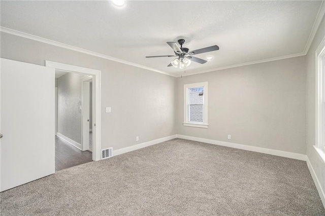 carpeted empty room with ornamental molding and ceiling fan