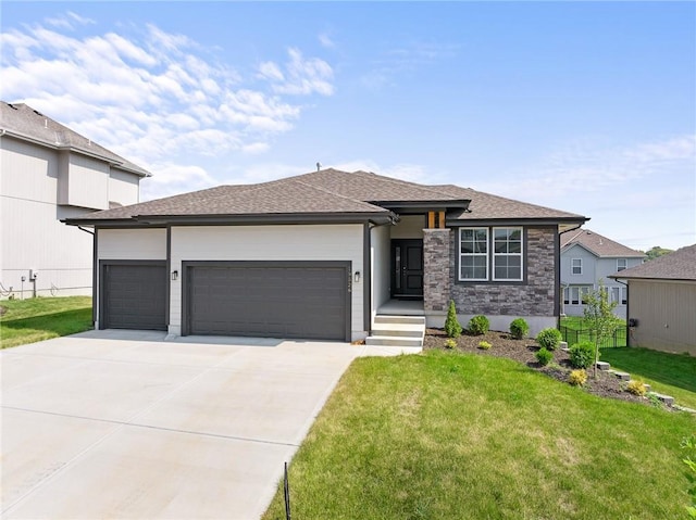 prairie-style house featuring a garage and a front lawn