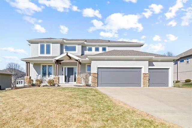 view of front of property with covered porch, a front yard, and a garage