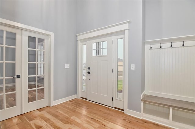 entryway with hardwood / wood-style flooring, plenty of natural light, and french doors