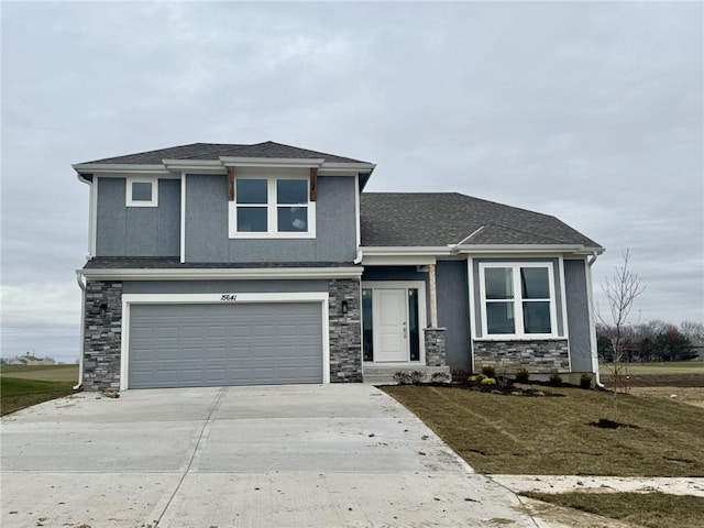 view of front of property featuring a garage and a front yard