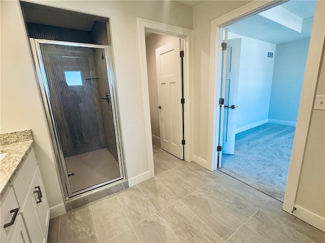 bathroom featuring vanity and an enclosed shower