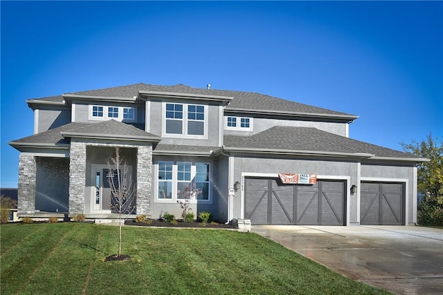 prairie-style home with a garage and a front yard