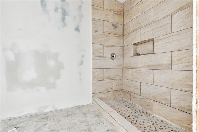 full bathroom featuring tiled shower