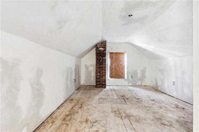 additional living space featuring lofted ceiling