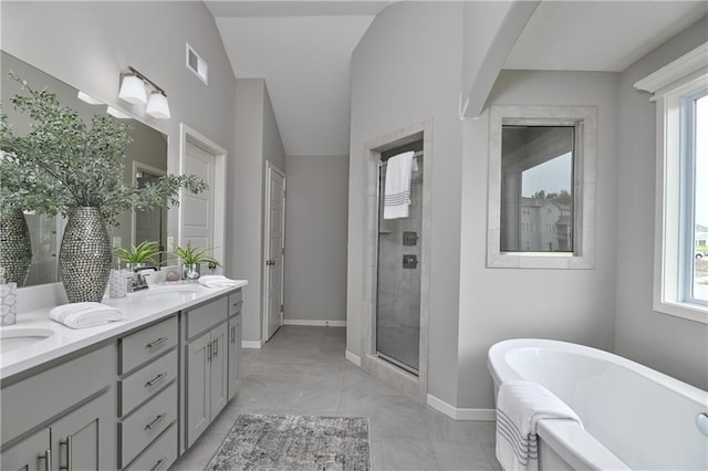 bathroom featuring vanity, tile patterned flooring, lofted ceiling, and independent shower and bath