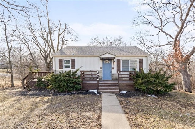 bungalow-style home with a shingled roof