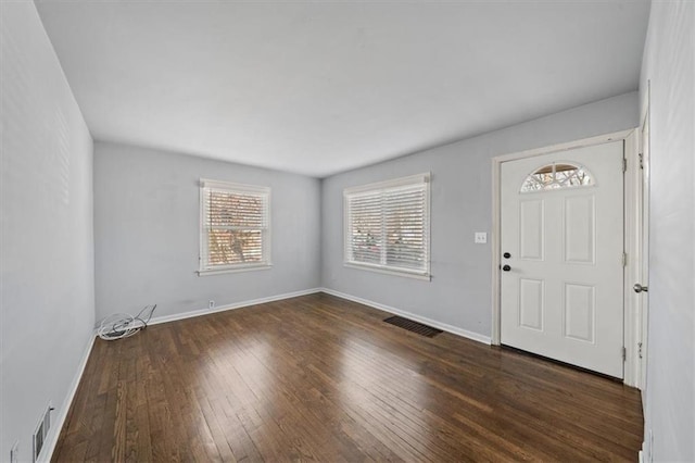 entrance foyer with wood-type flooring, visible vents, and baseboards