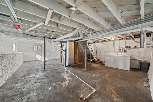 basement featuring stairway and washing machine and clothes dryer