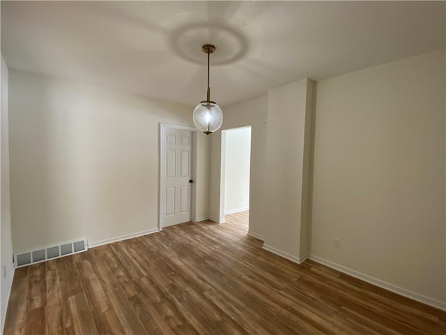 spare room with dark hardwood / wood-style flooring