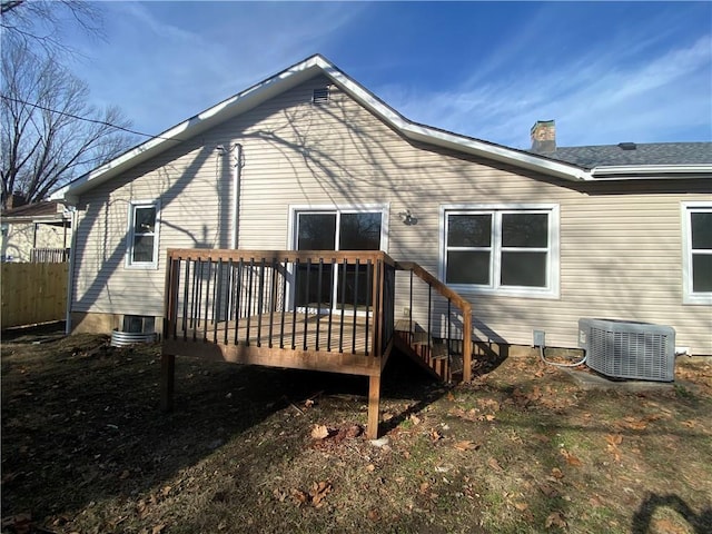 rear view of house featuring central AC and a deck