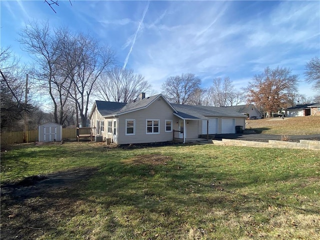 ranch-style home featuring a shed, a garage, and a front yard