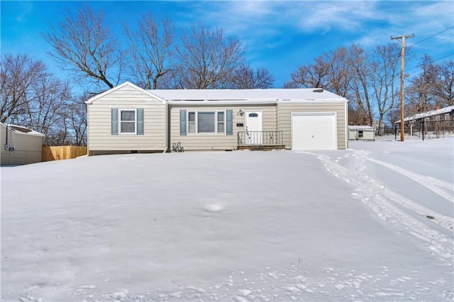 manufactured / mobile home featuring an attached garage and fence