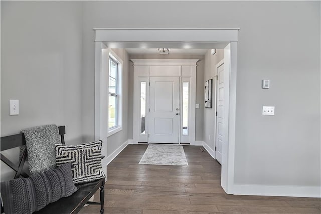 entryway featuring baseboards and dark wood finished floors