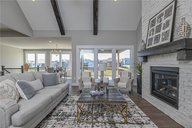 living area featuring lofted ceiling with beams, a fireplace, wood finished floors, and recessed lighting