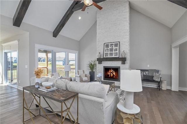 living area featuring a wealth of natural light, a fireplace, and wood finished floors