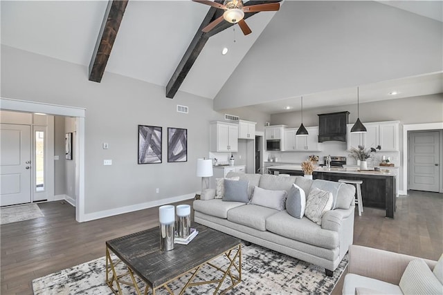 living area featuring dark wood finished floors, ceiling fan, high vaulted ceiling, beamed ceiling, and baseboards