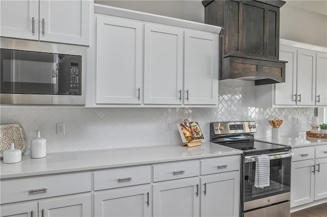 kitchen with light countertops, appliances with stainless steel finishes, and decorative backsplash