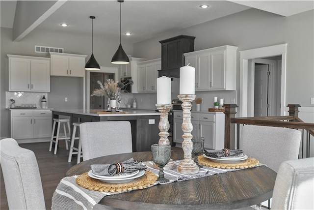 dining area featuring dark wood-style floors, visible vents, and recessed lighting