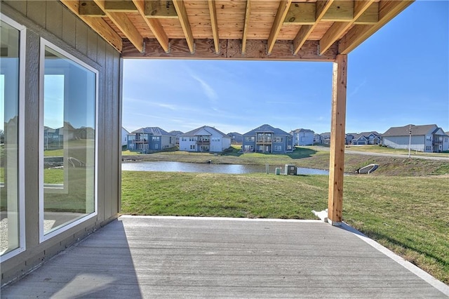 deck featuring a lawn, a water view, and a residential view