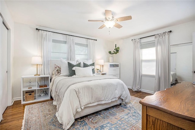 bedroom featuring wood finished floors, baseboards, and ceiling fan