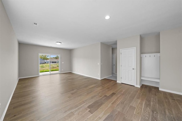 unfurnished living room with dark hardwood / wood-style floors