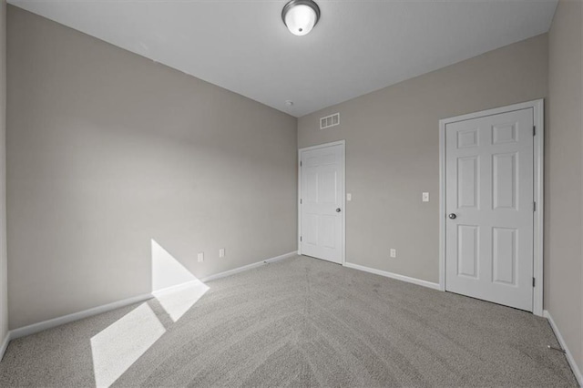 unfurnished bedroom featuring light colored carpet