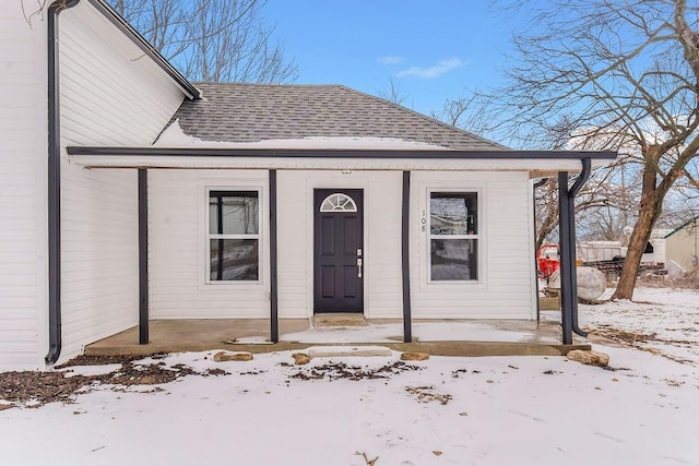 view of snow covered property entrance