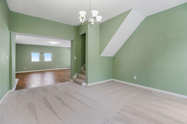 unfurnished room with carpet flooring and an inviting chandelier