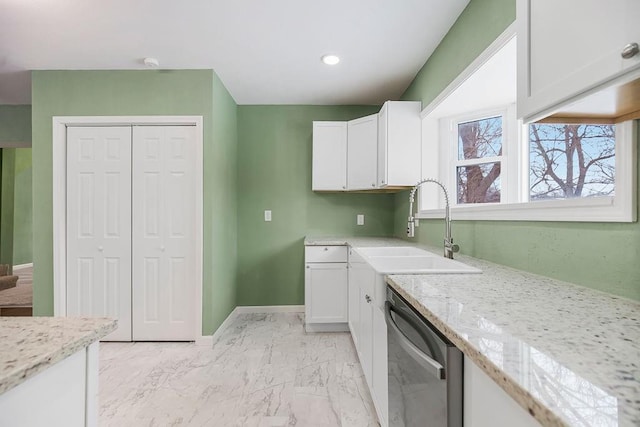 kitchen featuring white cabinets, light stone countertops, sink, and stainless steel dishwasher