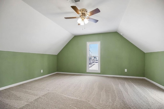 additional living space with ceiling fan, carpet floors, and lofted ceiling