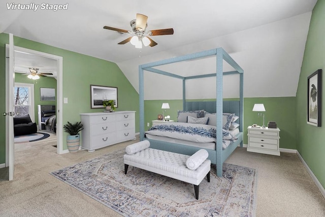 bedroom featuring vaulted ceiling, light colored carpet, and ceiling fan