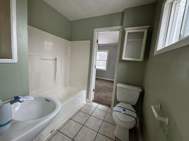 bathroom featuring shower / bathing tub combination, tile patterned floors, and toilet