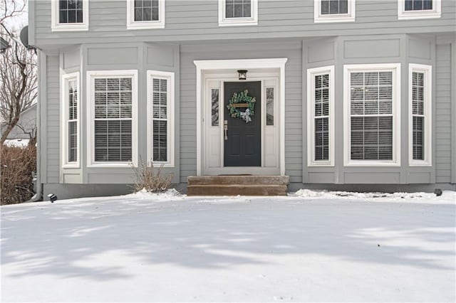 view of snow covered property entrance