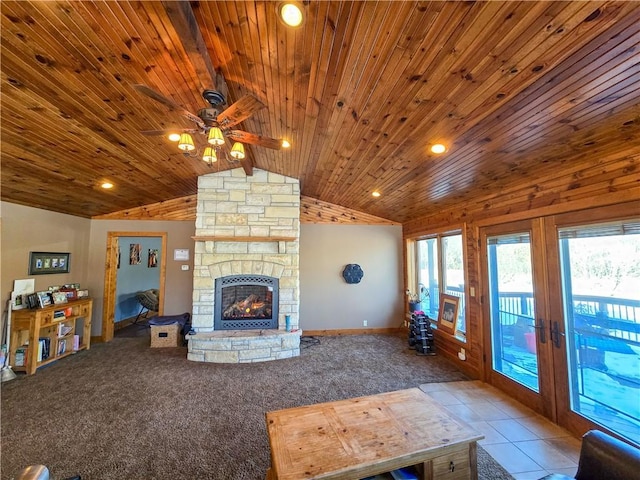 unfurnished living room with light colored carpet, a stone fireplace, vaulted ceiling, wooden ceiling, and french doors