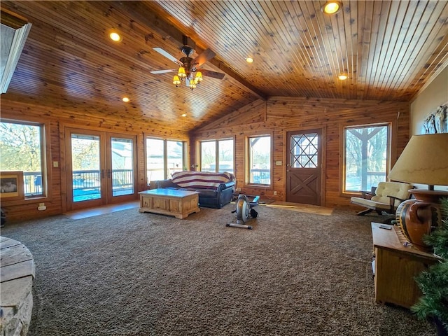 carpeted bedroom with wood walls, wooden ceiling, lofted ceiling with beams, and access to outside