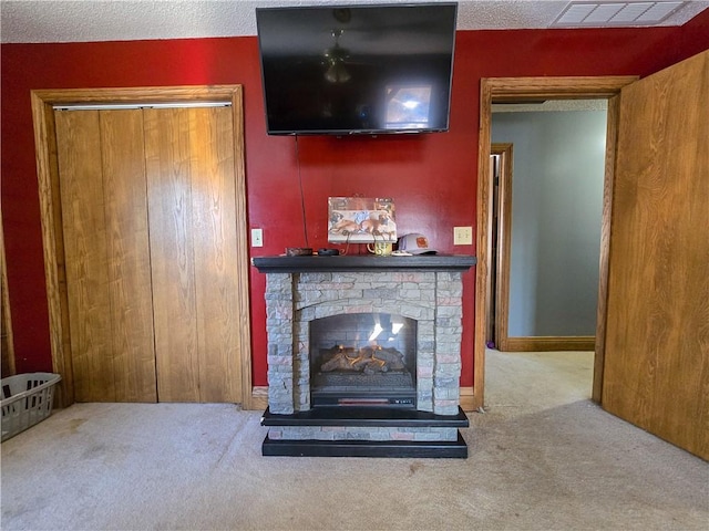 unfurnished living room featuring a stone fireplace, a textured ceiling, and carpet flooring