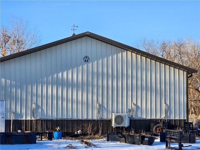 snow covered property with ac unit