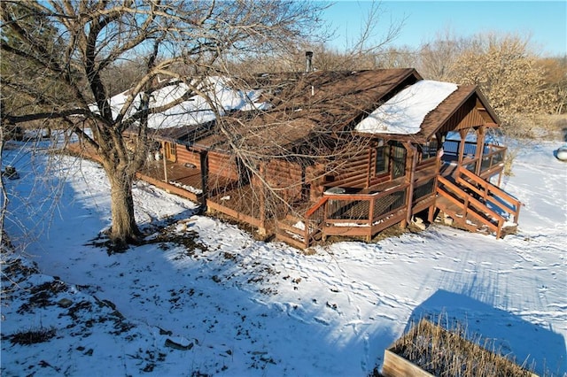 snow covered property with a deck