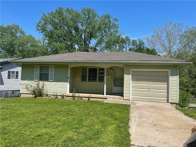 ranch-style home with an attached garage, concrete driveway, and a front yard