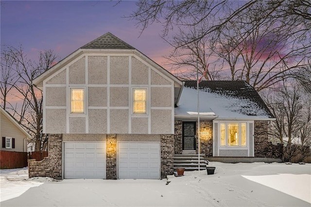 view of front of house with a garage, brick siding, and stucco siding